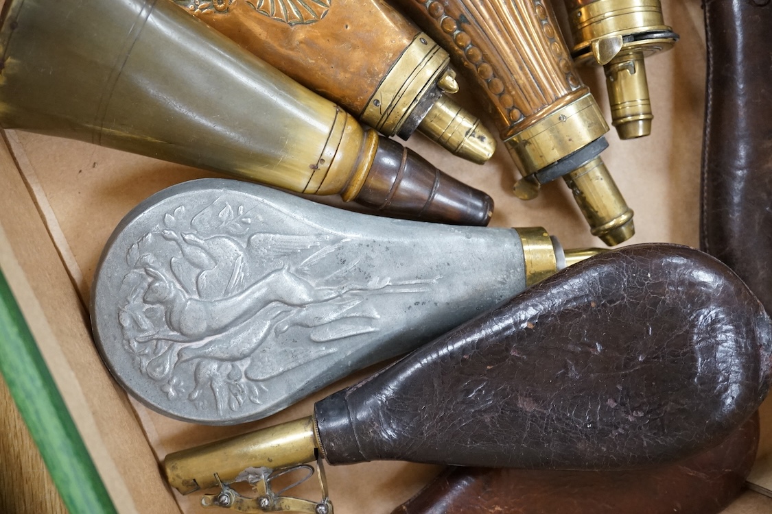 Nine powder flasks and shot flasks, all 19th century, comprising of two horn flasks, one flattened with brass mounts, three shot bags with sprung brass chargers, three copper gun flasks and another of zinc